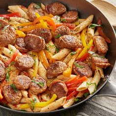 a skillet filled with pasta and sausage