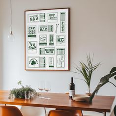 a wooden table topped with two brown chairs next to a wall mounted art piece on the wall