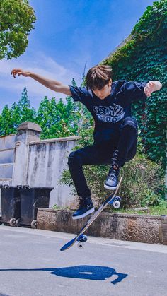 a skateboarder is doing a trick in the air with his board and one hand