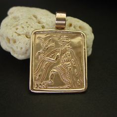 "Hand carved Sumerian jewelry of Annunaki god Enki. Enki also known as Ea was the Assyrian deity of crafts, mischief, water, seawater, lake water, intelligence and creation. His name literally means \"Lord of the Earth\". He was considered the master shaper of the world, god of wisdom and of all magic. Enki was considered a god of life and replenishment, and was often depicted with two streams of water flowing into his shoulders. Alongside him were trees symbolising the female and male aspects o Sumerian Jewelry, God Of Life, God Of Creation, God Of Wisdom, Streams Of Water, God's Wisdom, Tarpon Springs, Lake Water