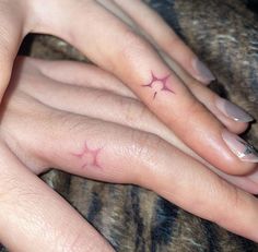 two fingers with small stars on them