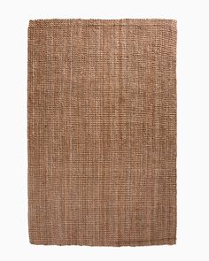 an area rug made out of jute and woven with brown color on the side