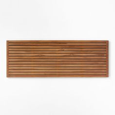 a wooden slatted wall hanging against a white wall