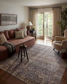 a living room filled with furniture and a large rug