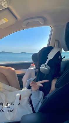 a woman sitting in the back seat of a car