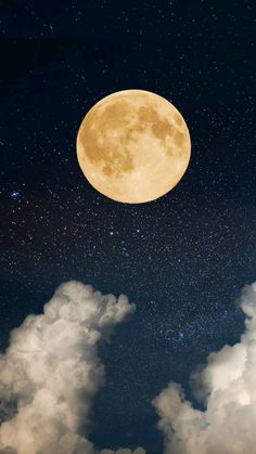 the full moon is shining brightly in the night sky above fluffy clouds and dark blue skies