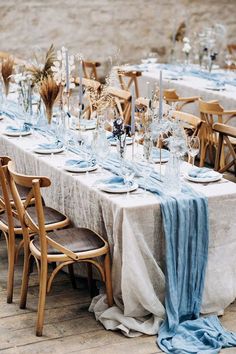 a long table is set with blue and white linens