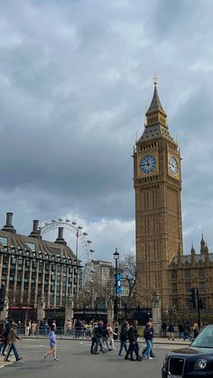 the big ben clock tower towering over the city of london on a partly cloudy day