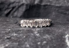 a diamond ring sitting on top of a rock