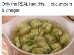 a white bowl filled with cucumbers on top of a table