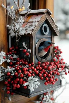 a birdhouse decorated with berries and lights