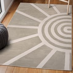 a gray and white area rug on the floor