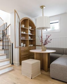 a living room filled with furniture and a spiral staircase