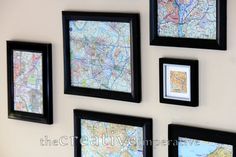 four black framed maps hang on the wall