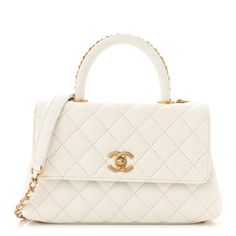 This is an authentic CHANEL Caviar Quilted Mini Coco Chain Handle Flap in White. This tote is crafted of diamond-stitched grained caviar leather in white. The shoulder bag features a top handle, a leather threaded aged gold chain-link shoulder strap and CC turn-lock closure. The flap opens to a partitioned white leather interior with a zipper and patch pocket. White Chanel Bag, Chanel Coco Handle, Luxury Tote Bags, Coco Handle, Chanel Purse, Travel Handbags, Chanel Caviar, Top Handle Handbags, Leather Thread