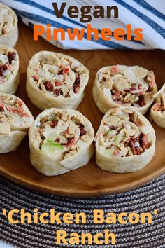 chicken bacon ranch pinwheels on a wooden platter with text that reads vegan pinwheels