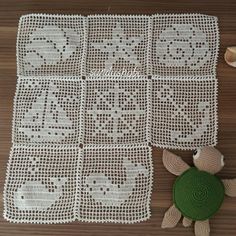 a crocheted baby afghan with a teddy bear on the floor next to it