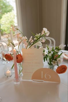 the table is set with flowers and candles