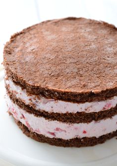 there is a cake that looks like it has been frosted with ice cream and strawberries