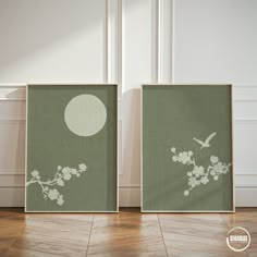 two framed pictures with birds and flowers on them in front of a white wall next to a wooden floor