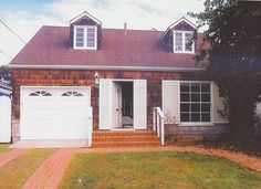 a brick house with white doors and windows