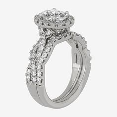 a white gold engagement ring with two rows of diamonds on the band and an oval shaped center