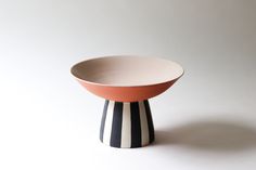 a black and white striped bowl sitting on top of a table