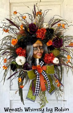 a wreath with an image of a woman wearing glasses and flowers on the front door