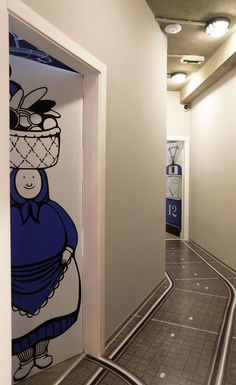 an empty hallway with cartoon characters painted on the walls