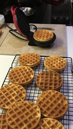 several waffles are cooling on a wire rack