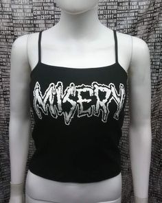 This is a black official Misery crop tank top with spaghetti straps. This has a Misery image screen printed on the front. 57% cotton/ 38% polyester/ 5% SpandexThese are handmade screenprinted and slightly vary from the photo. Please feel free to email me any questions. Thanks for looking.Due to an influx of incorrect addresses if a package is returned,  you must pay the shipping cost to resend the item to you.I do not do exchanges and I do not take returns unless the item is damaged. I thoroughl Trendy Screen Print Tank Top For Streetwear, Y2k Black Tank Top With Letter Print, Black Grunge Tank Top With Letter Print, Edgy Black Letter Print Tank Top, Edgy Black Tank Top With Letter Print, Edgy Streetwear Tank Top With Letter Print, Grunge Graphic Print Tank Top For Summer, Summer Grunge Graphic Print Tank Top, Edgy Letter Print Tank Top