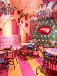 the interior of a restaurant decorated in pink and green with lots of polka dots on the walls