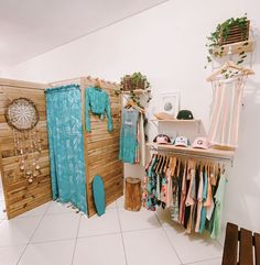 a room with clothes hanging on the wall and other items in front of it,