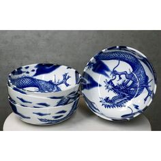 two blue and white bowls with dragon designs