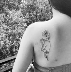 a woman with a flower tattoo on her back