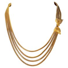 This mid-century shiny yellow-gold-plated snake-chain multi-strand necklace features a sculptural finely-textured gilt-metal bow that is positioned to rest on the upper left chest to function as a hook-and-eye clasp. Among the four graduated chains on the unsigned necklace, the shortest is 18 inches long. As an eye-visible sign of normal wear and age, there is gold loss on the upper part of the hook that is unseen when fastened. Also, if running fingers along the snake chains, a kink can be felt Metal Bow, American Modern, The Snake, Multi Strand Necklace, Strand Necklace, Multi Strand, Snake Chain, The Four, Metallica