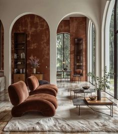 a living room with large arched windows and lots of furniture