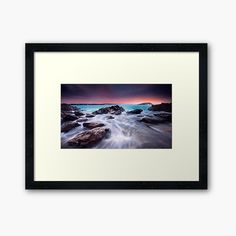 an ocean scene with rocks and water framed art print