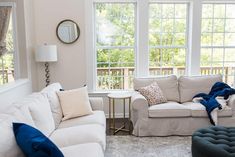 a living room filled with furniture and windows