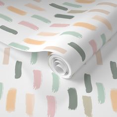 a white wallpaper with multicolored brush strokes on it's paper roll