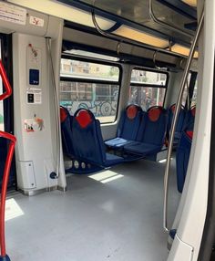 the inside of a bus with blue and red seats