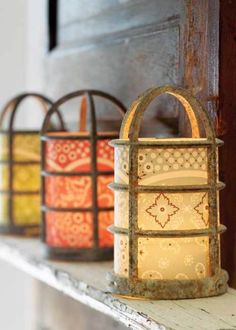 several lanterns are lined up on a shelf