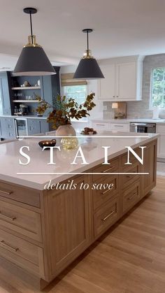 a large kitchen island with two pendant lights over it and the words stain details to save