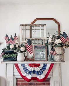 an american flag garland on top of a fireplace mantel