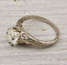 an antique style ring with a diamond in the center