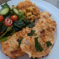 a white plate topped with fried food and vegetables