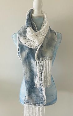 a mannequin wearing a scarf with fringes on it