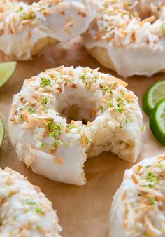 the doughnuts are covered with white frosting and sprinkled with lime