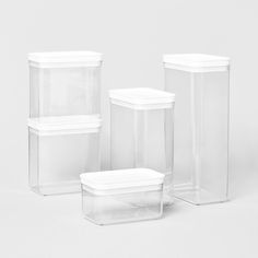 three clear plastic containers with lids on white background