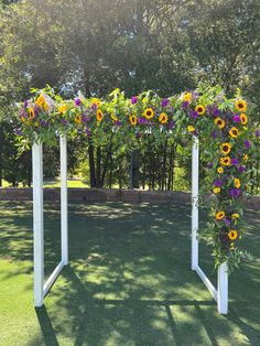 an outdoor wedding ceremony with sunflowers and greenery